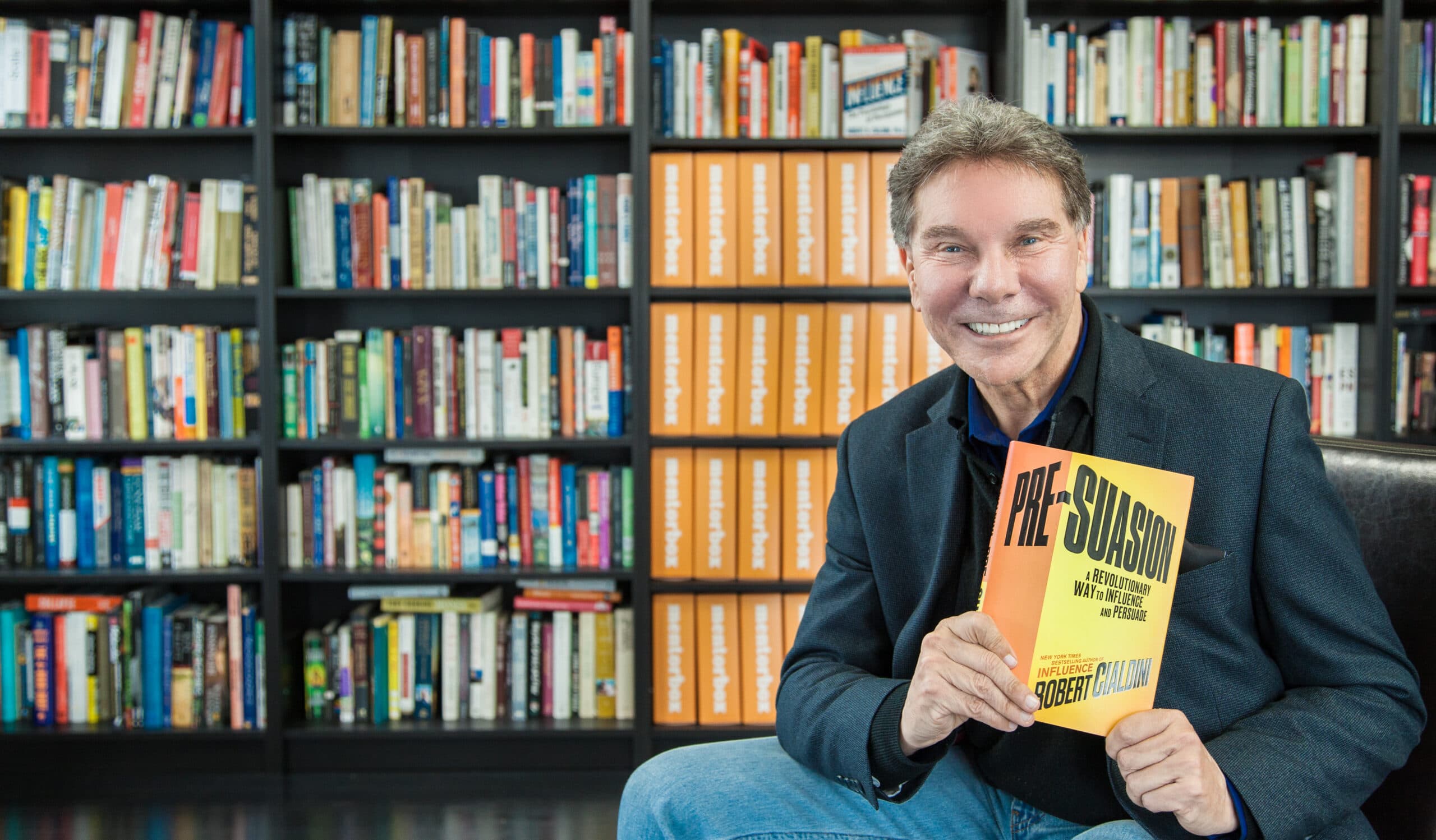 Dr. Cialdini holding a copy of Pre-Suasion